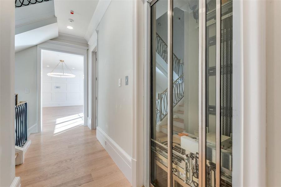 Hallway with light hardwood / wood-style floors