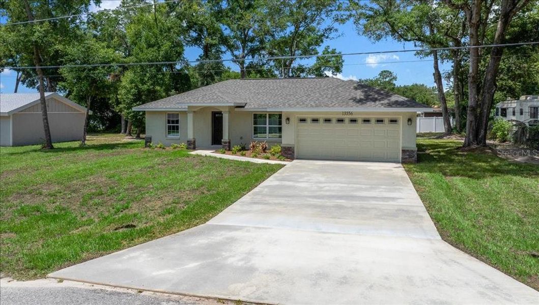 Front exterior of a new home in , Belleview, FL, highlighting curb appeal (Image 16).
