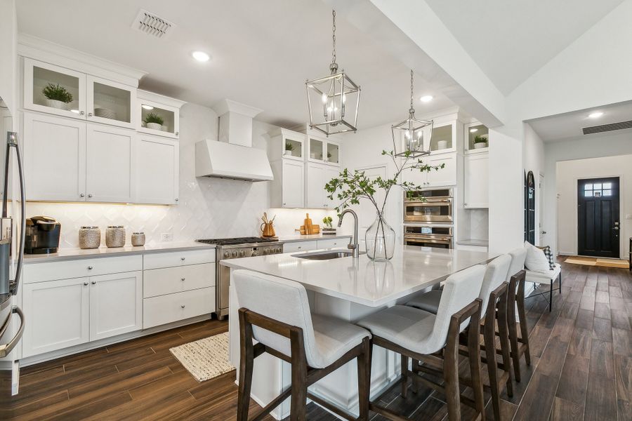 Kitchen with pendant lighting and glass upper cabinets