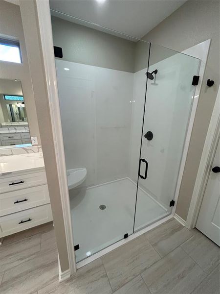 Bathroom with a stall shower and vanity