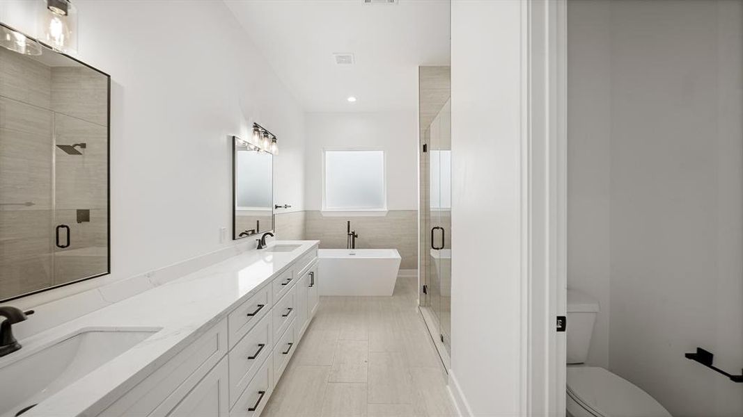 This amazing master en-suite is highlighted by tile floors, dual sinks, granite countertops, and soft closing drawers.