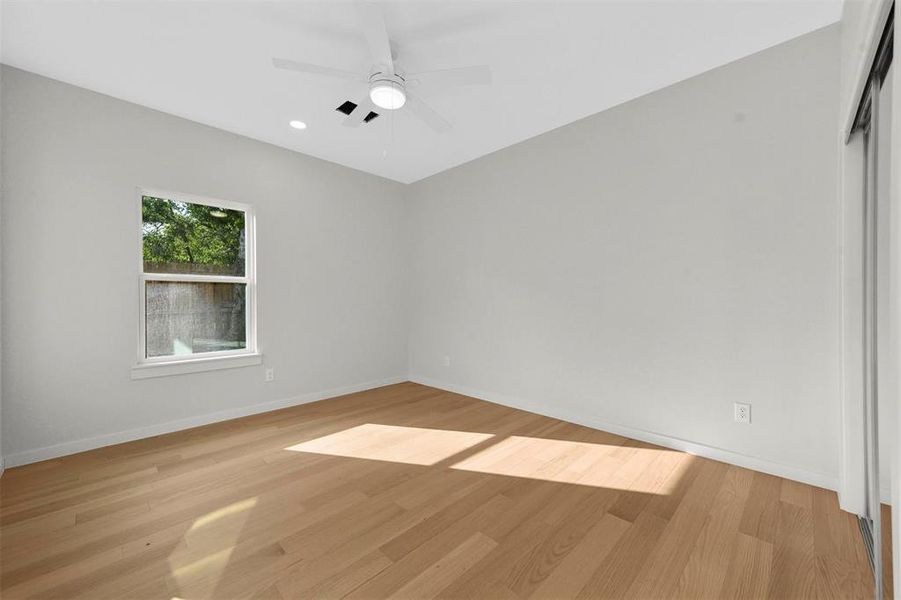 Empty room featuring ceiling fan and light hardwood / wood-style flooring