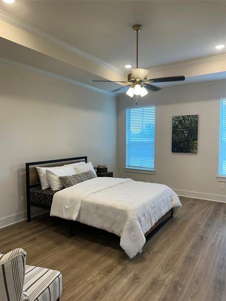 Spacious room featuring wood-finish flooring, recessed lighting, and a ceiling fan with integrated lighting
