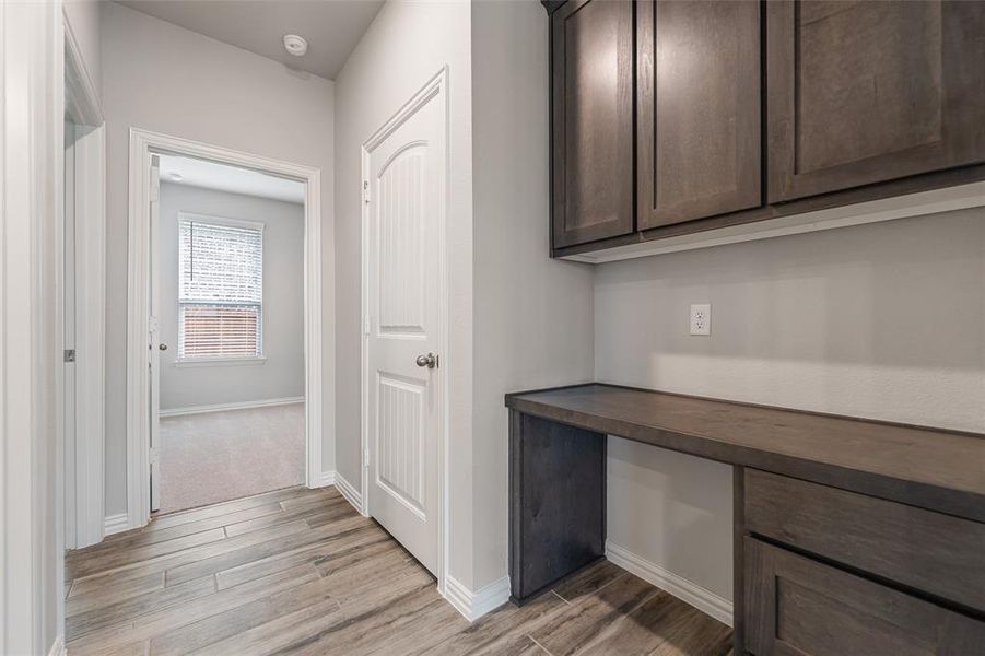 Corridor with baseboards and light wood-style flooring Corridor with baseboards and light wood-style flooring