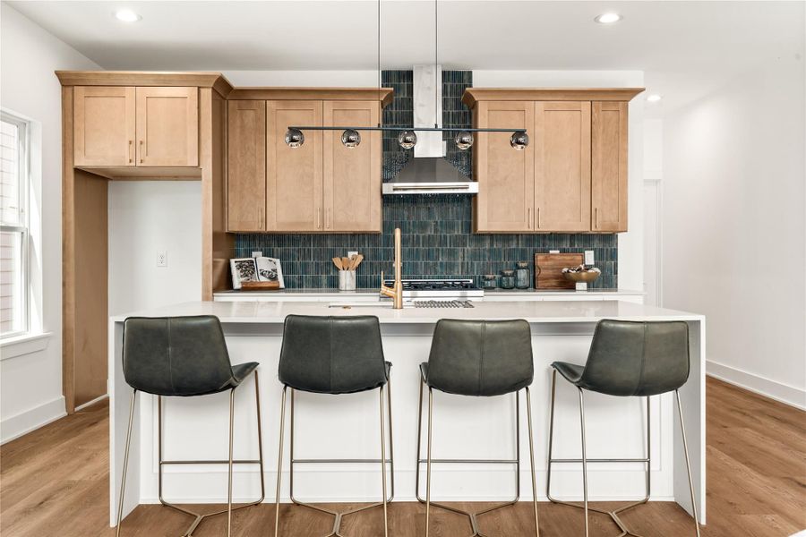 A generous waterfall quartz island gives everyone a seat without crowding the kitchen. A generous waterfall quartz island gives everyone a seat without crowding the kitchen.