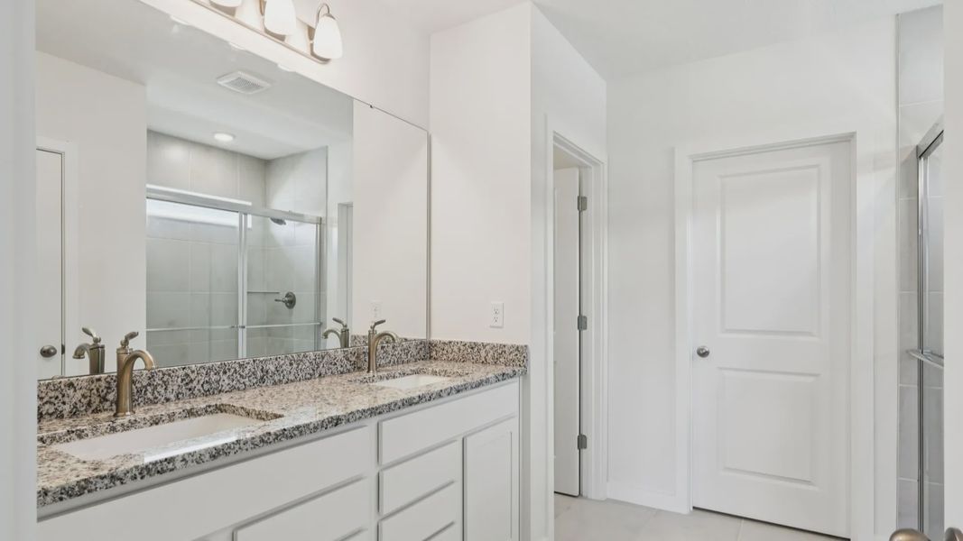 Primary En Suite Bath of the Baker Floor Plan by DRB Homes in Liberty Trace New Homes in Haines City