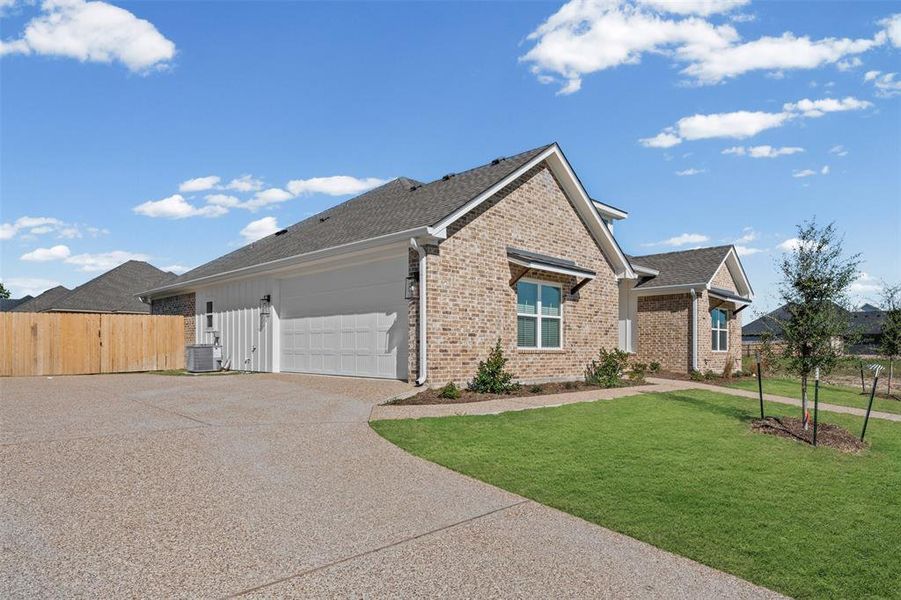 View of front of property with driveway, brick siding, a shingled roof, and an attached garage View of front of property with driveway, brick siding, a shingled roof, and an attached garage