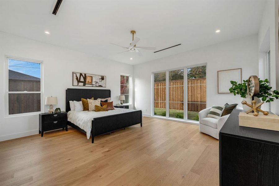 Bedroom with light wood-style flooring, recessed lighting, and a ceiling fan Bedroom with light wood-style flooring, recessed lighting, and a ceiling fan