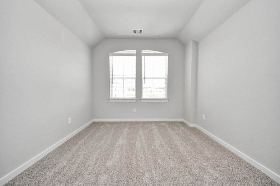 Secondary bedroom features plush carpeting, large windows that let in plenty of natural light, bright paint, and spacious closets. Secondary bedroom features plush carpeting, large windows that let in plenty of natural light, bright paint, and spacious closets.