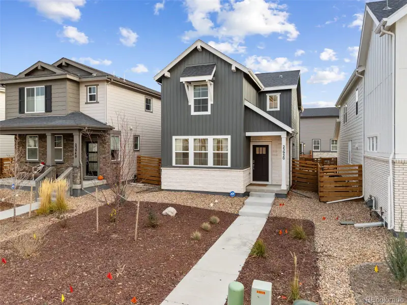 Front exterior of a new home in The Aurora Highlands Horizon Collection, Aurora, CO, highlighting curb appeal (Image 1).