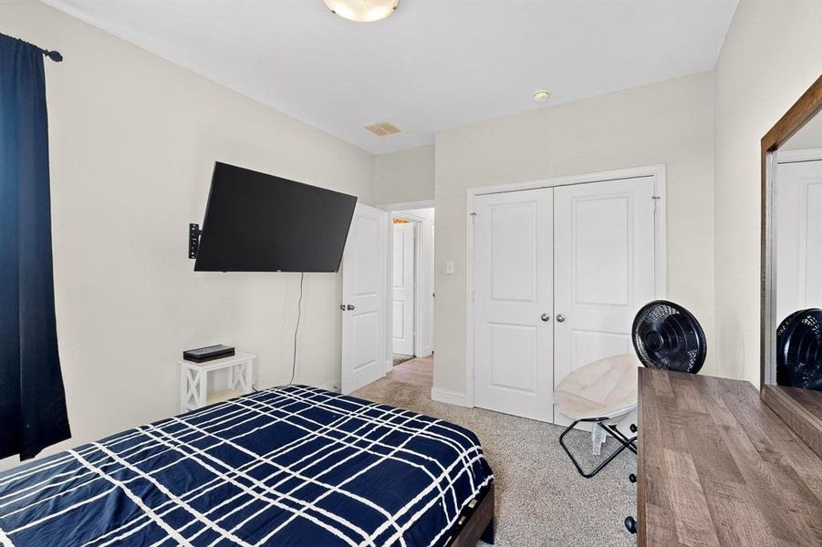 Bedroom with carpet and a closet Bedroom with carpet and a closet