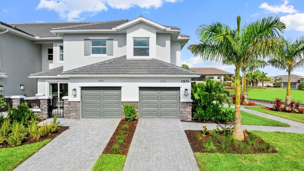 Front exterior of a new home in Esplanade by the Islands, Naples, FL, highlighting curb appeal (Image 1). Front exterior of a new home in Esplanade by the Islands, Naples, FL, highlighting curb appeal (Image 1).