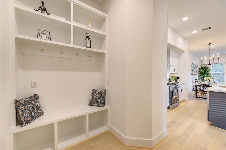 Mudroom features a custom built bench and storage space