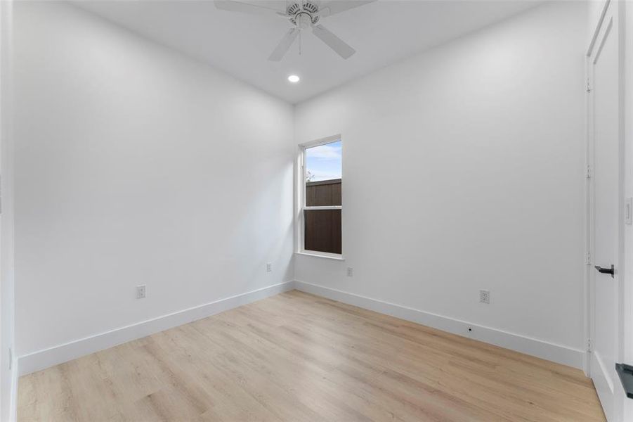 Unfurnished room with light wood-style floors, a ceiling fan, and recessed lighting