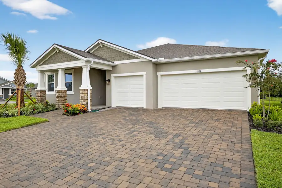 Front exterior of a new home in Windwater, Parrish, FL, highlighting curb appeal (Image 1).
