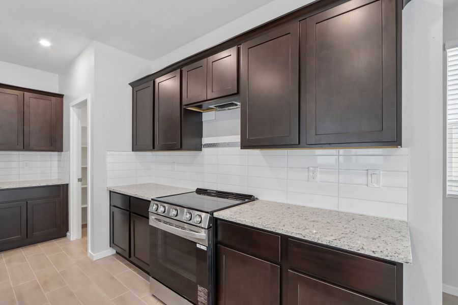 A kitchen with black cabinets.