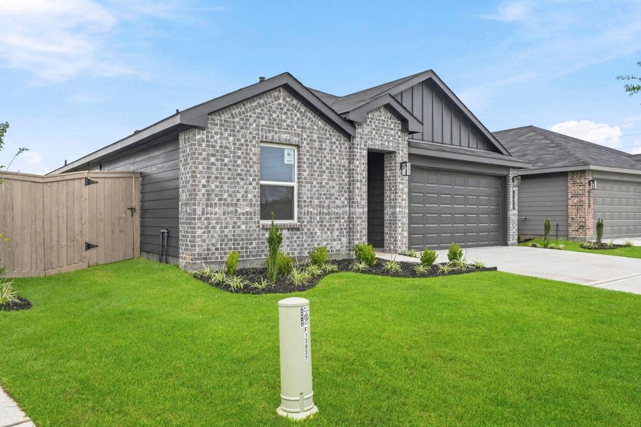 Front exterior of a new home in The Canopies, Splendora, TX, highlighting curb appeal (Image 2). Front exterior of a new home in The Canopies, Splendora, TX, highlighting curb appeal (Image 2).
