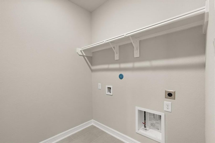 The laundry room layout is carefully planned for optimal workflow with designated areas for washing, drying, and storing.