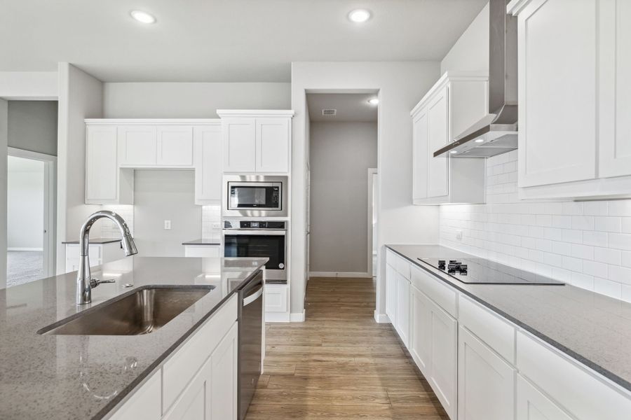 Kitchen in the Bowie home plan by Trophy Signature Homes – REPRESENTATIVE PHOTO