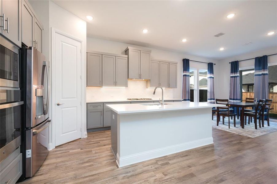 Large island features counter seating which is great for conversing with family and friends or grabbing a quick bite to eat.