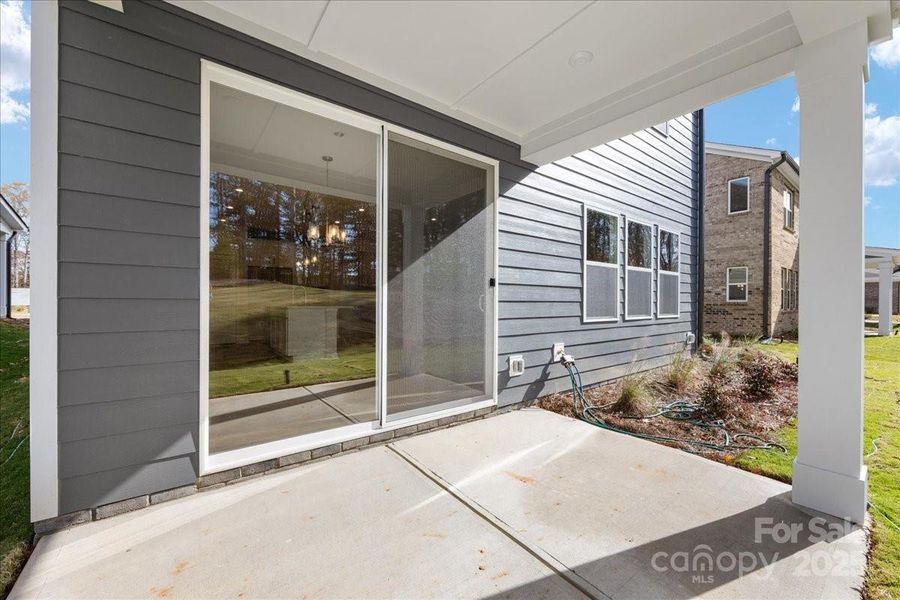 Covered Rear Outdoor Living Through Sliding Glass Doors.