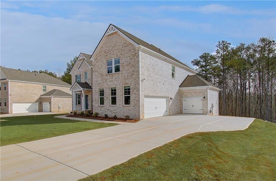 Front exterior of a new home in Trinity Park, McDonough, GA, highlighting curb appeal (Image 2). Front exterior of a new home in Trinity Park, McDonough, GA, highlighting curb appeal (Image 2).