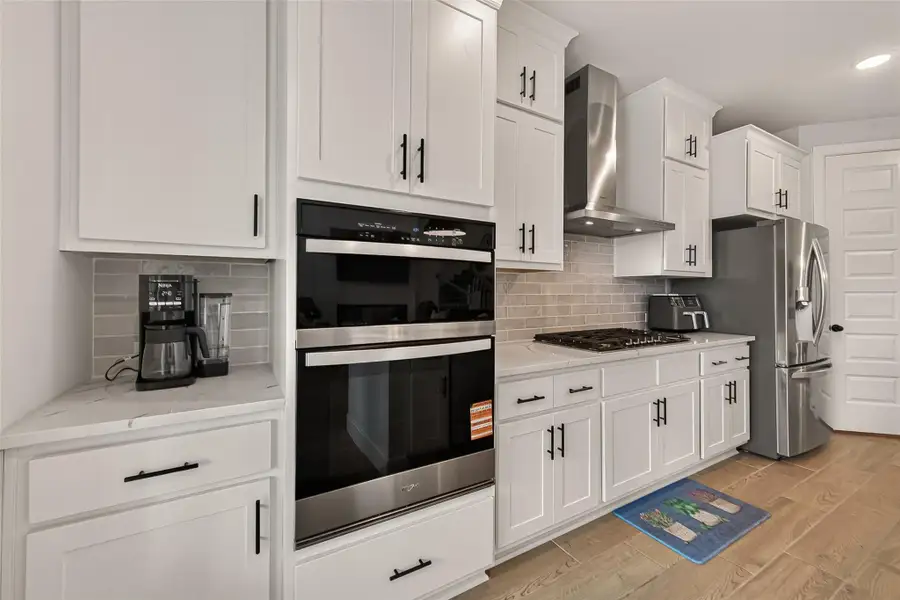Sleek stainless steel appliances complete the modern kitchen. Sleek stainless steel appliances complete the modern kitchen.