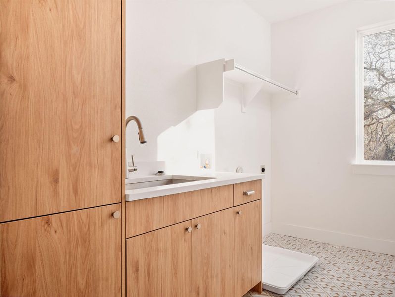 Laundry room with cabinet space, washer hookup, hookup for an electric dryer, and light floors