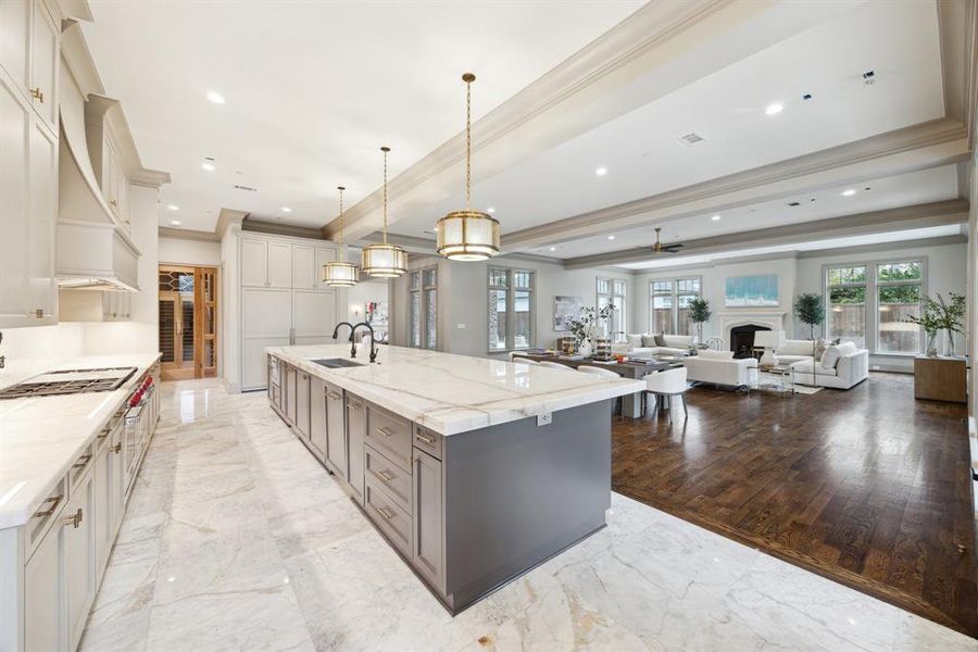 Another view of this stunning space highlights its open design. To the left of the wine room, a hallway leads to the downstairs laundry, mudroom, and garage, combining elegance with practicality.