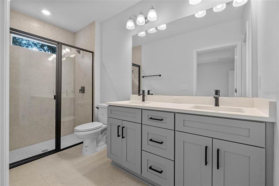 Primary Bathroom w/ dual sinks and walk in shower