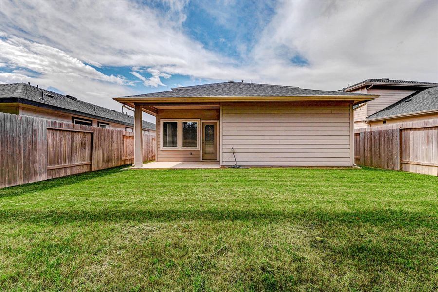 Step into this fully enclosed backyard retreat with a large grassy area and an extended covered patio, ideal for entertaining or peaceful evenings under the stars. With plenty of room for pets, outdoor games, or future enhancements, this backyard delivers comfort, flexibility, and privacy in one perfect outdoor space. Step into this fully enclosed backyard retreat with a large grassy area and an extended covered patio, ideal for entertaining or peaceful evenings under the stars. With plenty of room for pets, outdoor games, or future enhancements, this backyard delivers comfort, flexibility, and privacy in one perfect outdoor space.