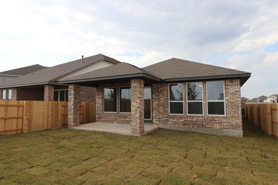 Front exterior of a new home in Flora, Hutto, TX, highlighting curb appeal (Image 2).