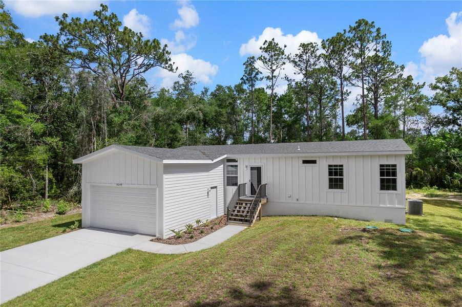 Front exterior of a new home in , Weeki Wachee, FL, highlighting curb appeal (Image 20). Front exterior of a new home in , Weeki Wachee, FL, highlighting curb appeal (Image 20).