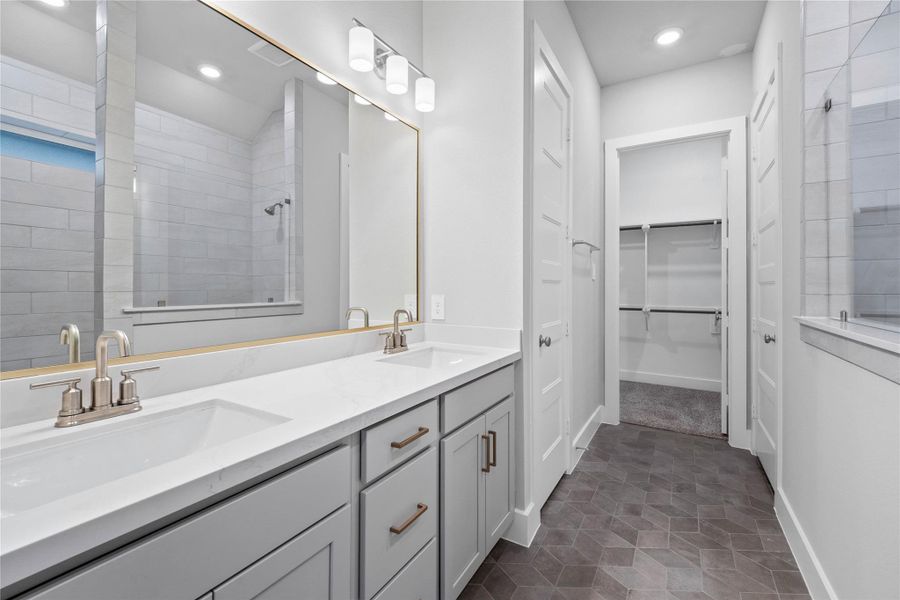 This spa-inspired primary bathroom is designed with modern, clean lines and elegant finishes.
