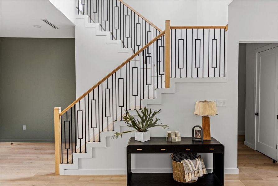 Stairs with wood finished floors and baseboards