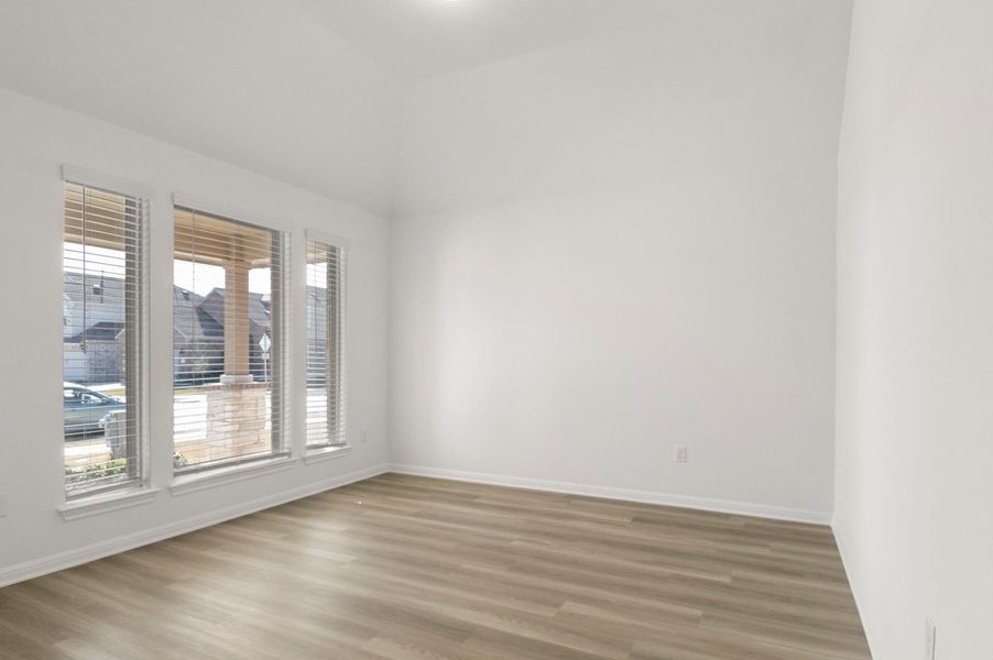 Empty room with light wood-type flooring and baseboards