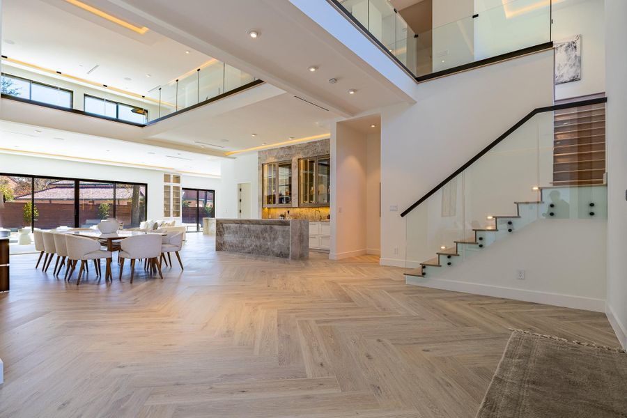 Grand double-height foyer with floating staircase and dramatic architectural scale. Grand double-height foyer with floating staircase and dramatic architectural scale.