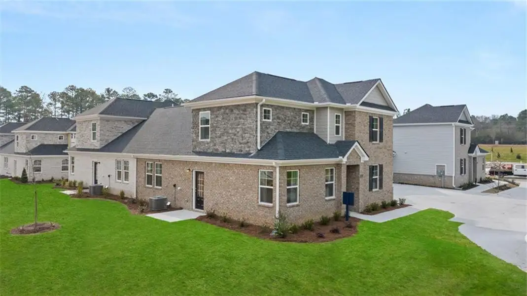 Front exterior of a new home in Independence Villas and Townhomes, Loganville, GA, highlighting curb appeal (Image 18). Front exterior of a new home in Independence Villas and Townhomes, Loganville, GA, highlighting curb appeal (Image 18).