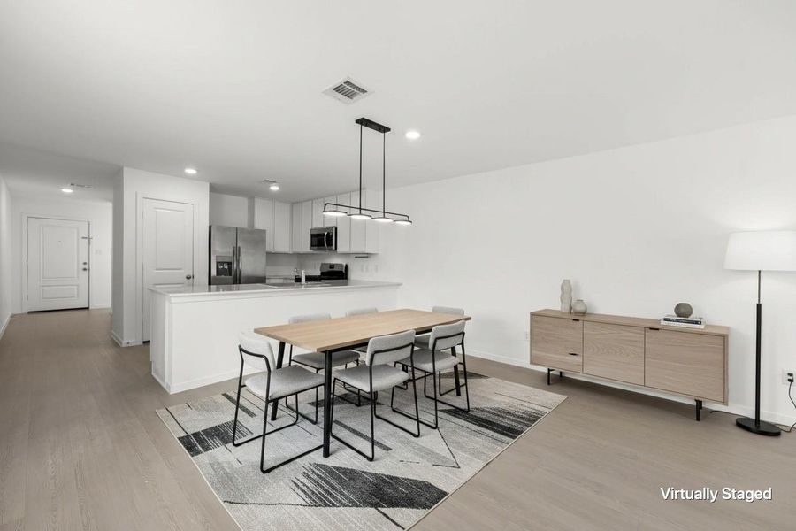 Virtually staged dining space illustrates a generous dining arrangement adjacent to the open kitchen, complemented by contemporary pendant lighting and durable flooring. Virtually staged dining space illustrates a generous dining arrangement adjacent to the open kitchen, complemented by contemporary pendant lighting and durable flooring.