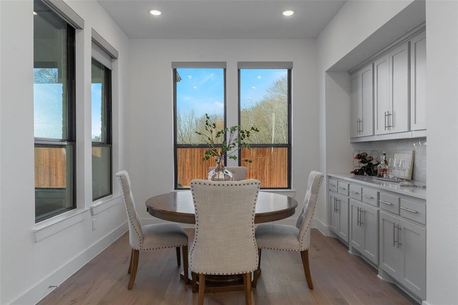 Dining area with baseboards, wood finished floors, and recessed lighting