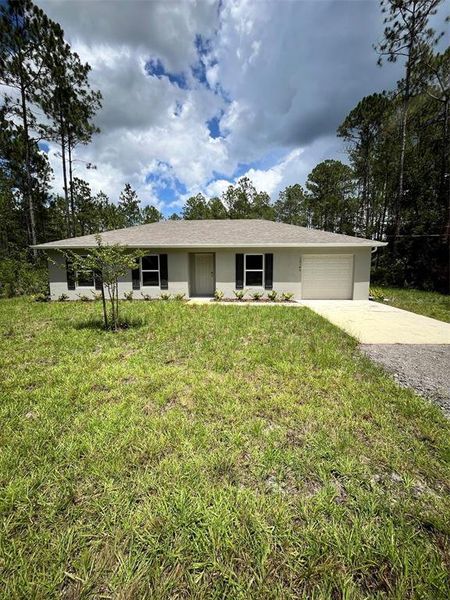 Front exterior of a new home in Flagler Estates, Hastings, FL, highlighting curb appeal (Image 1).