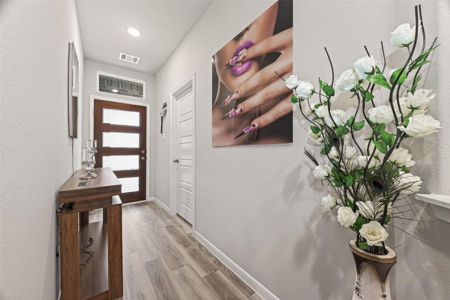Vinyl plank flooring and a sun-soaked foyer welcome you into a home that feels fresh and modern.
