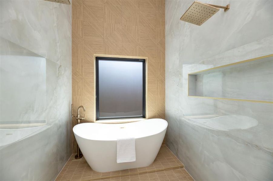 Bathroom featuring a freestanding bath, tile walls, and tile patterned floors Bathroom featuring a freestanding bath, tile walls, and tile patterned floors