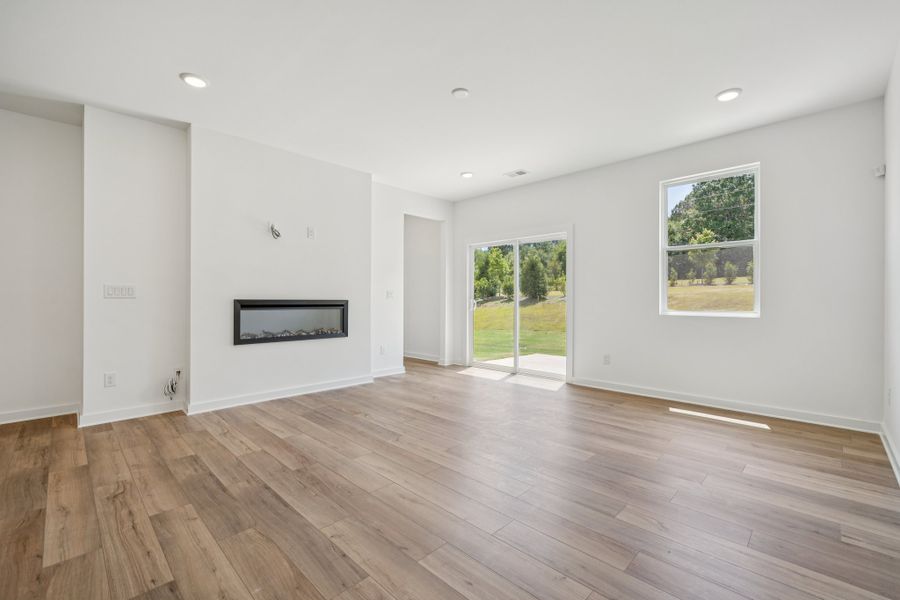 A room with white walls and a wood floor with a wood floor.