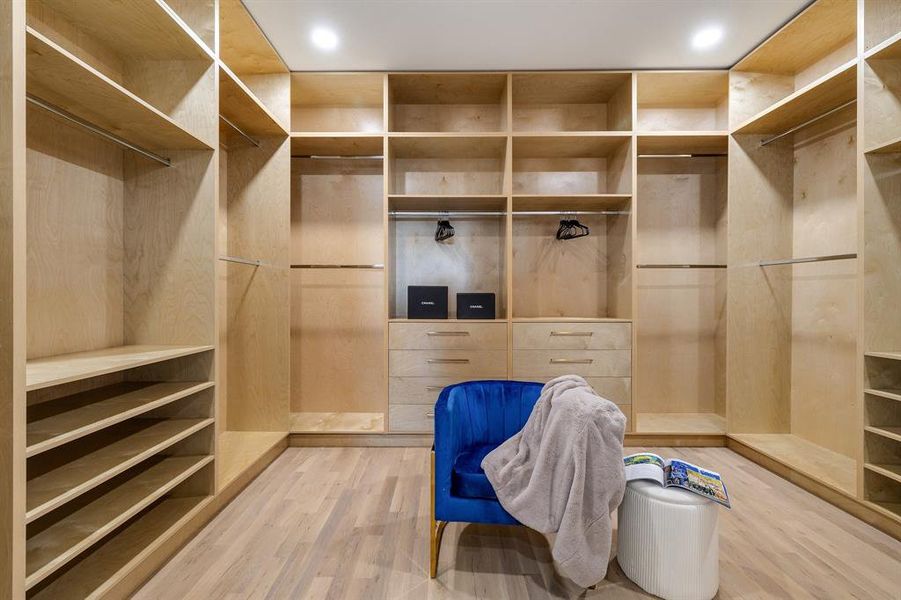 Spacious closet with hardwood / wood-style floors