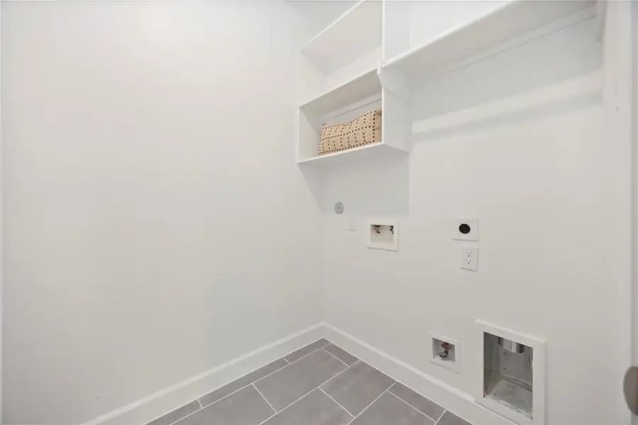 Located on the second floor, the laundry room offers convenience with space for side-by-side washer and dryer, complemented by hang and shelf space and an additional closed (not pictured)