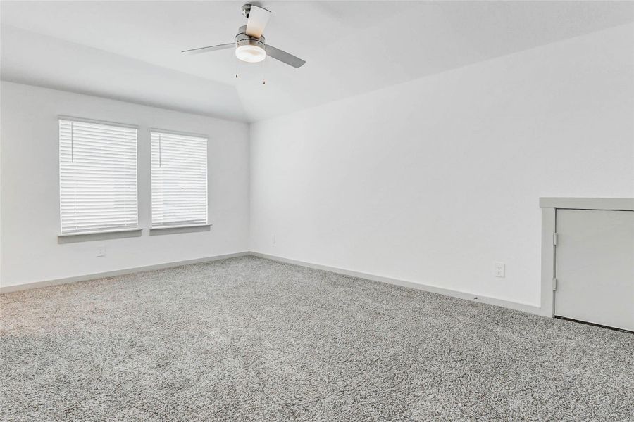 This spacious room offers ample natural light from two large windows, a modern ceiling fan, and vaulted ceilings for an added sense of space. A perfect setup for your game room or media room can easily double as your creative studio, or upper-level flex space. This spacious room offers ample natural light from two large windows, a modern ceiling fan, and vaulted ceilings for an added sense of space. A perfect setup for your game room or media room can easily double as your creative studio, or upper-level flex space.