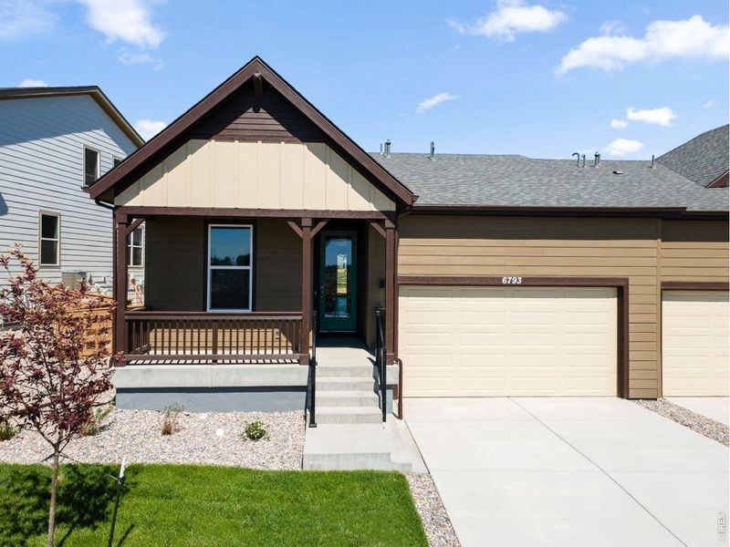 Front exterior of a new home in Cordovan, Longmont, CO, highlighting curb appeal (Image 1). Front exterior of a new home in Cordovan, Longmont, CO, highlighting curb appeal (Image 1).