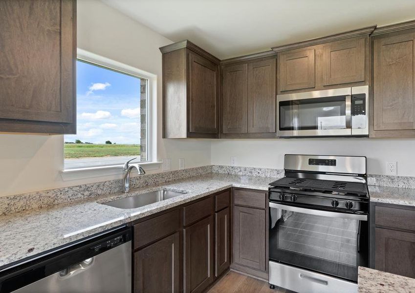 The kitchen has sprawling granite countertops.