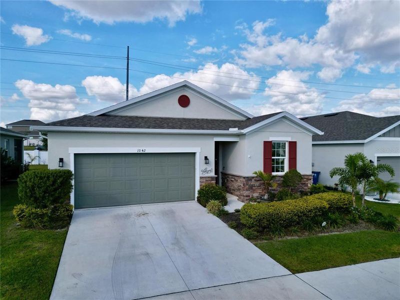 Front exterior of a new home in Seasons at Heritage Square, Haines City, FL, highlighting curb appeal (Image 31). Front exterior of a new home in Seasons at Heritage Square, Haines City, FL, highlighting curb appeal (Image 31).